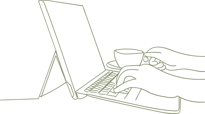 one hand typing up a business plan while other hand holds a cup of coffee